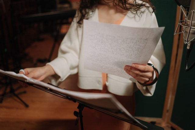 Singer in studio with lyrics